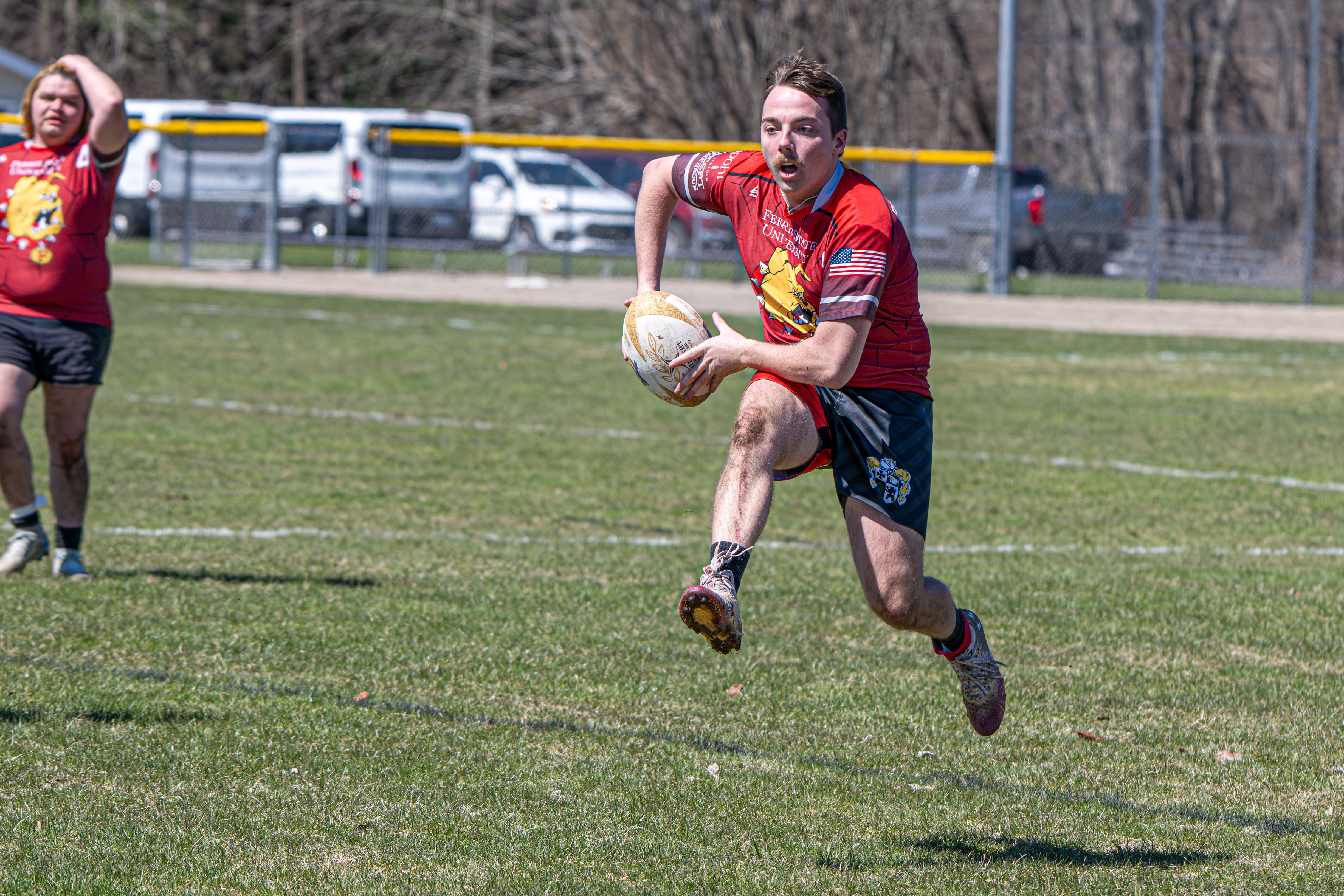 Ferris State rugby player sprinting into space with the ball