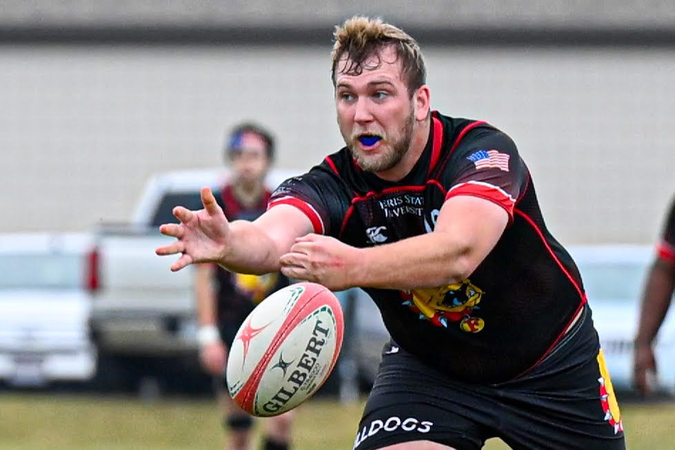 Ferris State rugby player passing the ball to a teammate